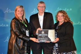 Minister of Alberta Agriculture and Rural Development poses with Tracy and Tami Gardner of the ORE Administrative staff.